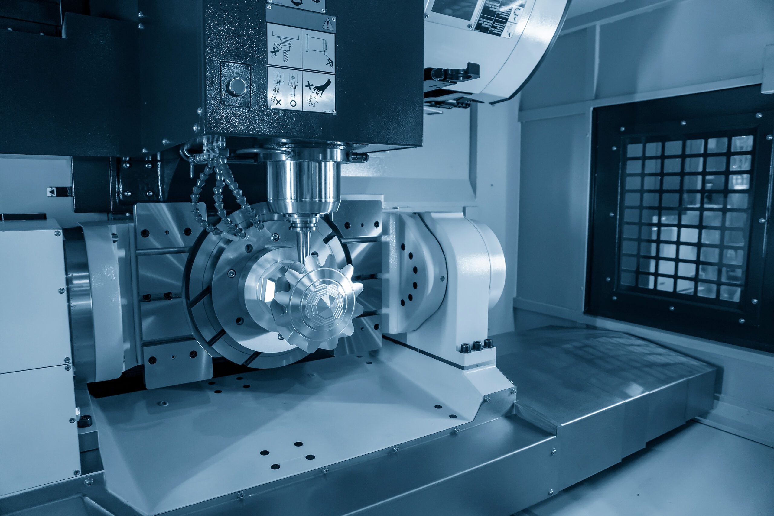 The 5 axis CNC machining center cutting the mechanical parts with solid ball end-mill tools. The hi-technology mechanical part manufacturing process by 5 axis CNC milling machine.